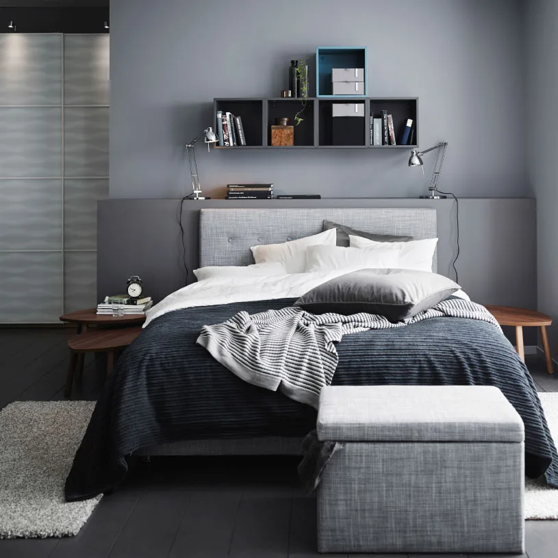 A grey bedroom with a grey ÅRVIKSAND divan bed, a grey TUSENSKÖNA bed spread and a grey FJÄRA storage box.