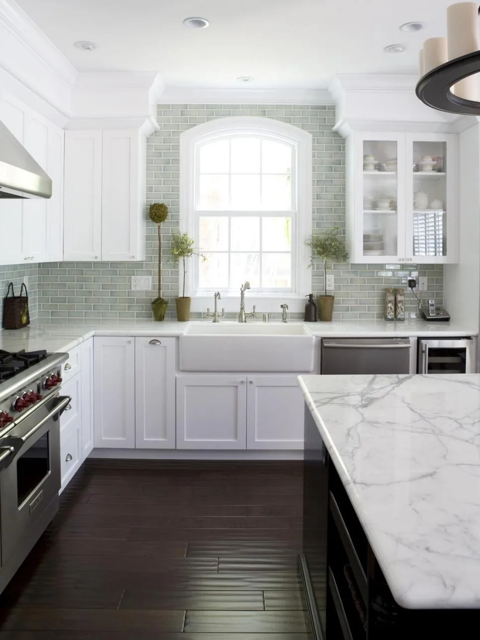 http://hgtvhome.sndimg.com/content/dam/images/hgtv/fullset/2012/6/12/2/DP_Fiorella-Design-White-Kitchen-Sink-Island_s3x4.jpg.rend.hgtvcom.966.1288.suffix/1400975523270.jpeg